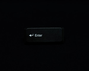 Leinwandbilder - Black keyboard Enter button isolated on black background