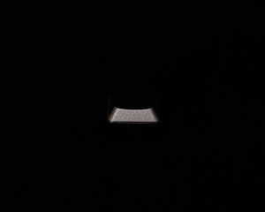 Leinwandbilder - Black keyboard button isolated on black background