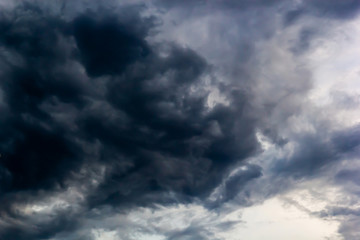 Dark clouds and blue dramatic sky with intense black cloud before raining, tropical cyclone in the rainy season