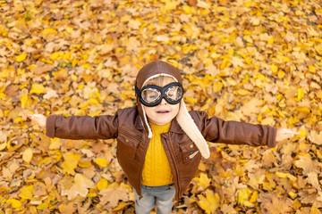 Poster - Happy child having fun outdoor in autumn park