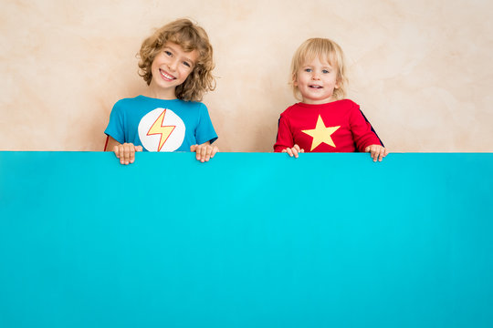 superheroes children holding blue banner blank