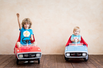 Wall Mural - Superheroes children driving toy cars at home