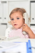 © aletia2011 - Cute little girl using phone in office