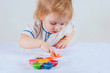 © got - The baby draws on paper with finger paints.