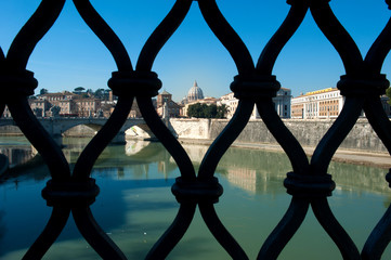 Wall Mural - different view from Ponte San Angelo of the basilica of San Pietro and the Tiber river behind the grates