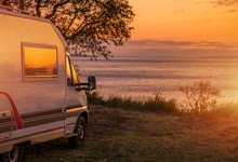 Waterfront RV Camping Site During Scenic Sunset.