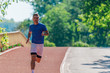 © qunica.com - Handsome man jogging during sunny morning out on the race track