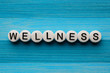 Wellness text on a blue wooden table
