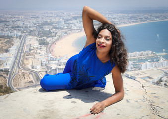 Beautiful girl on the background of a panoramic view of the city of Agadir.