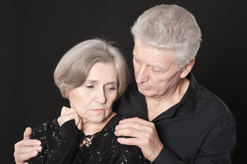 Portrait of sad senior couple posing at home