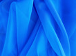 canvas print picture - Textiles and textures. Crumpled organza close-up. Fabric background. tinted in a modern trendy color classic blue
