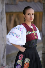 Young beautiful slovak woman in traditional costume. Slovak folklore.