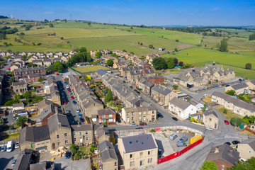 Canvas Print - Aerial drone photo of the beautiful town of Mirfield in Kirklees, West Yorkshire, England showing the village houses on a beautiful sunny summers day