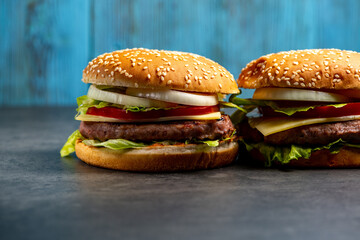 2 burgers on a blue wooden background