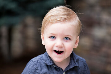 Excited little boy face with mouth open and cute gap between front teeth