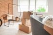 © Pixel-Shot - Cardboard boxes with belongings in new flat on moving day