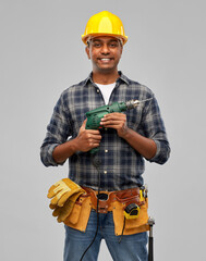 Poster - profession, construction and building - happy smiling indian worker or builder in helmet with electric drill or perforator over grey background