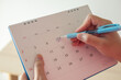 © Kwangmoozaa - Hand with pen mark at 5th on calendar date with blue circle