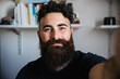 © loreanto - Portrait of friendly blogger smiling bearded hipster man taking a selfie in lockdown from Coronavirus, Covid-19 - Concept of video call teacher job in interview call recording vlog webinar with webcam