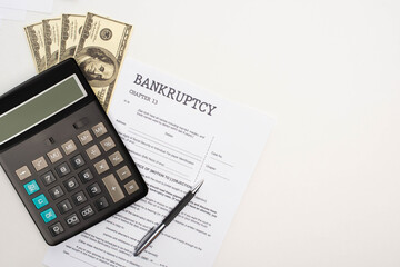 Wall Mural - top view of bankruptcy paper with pen, money and calculator on white background