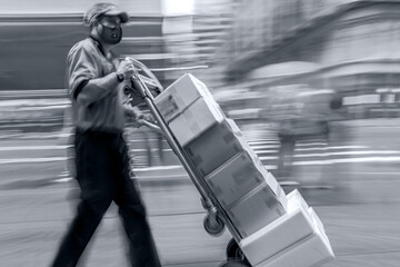 Wall Mural - delivery with a cart manually in medical masks