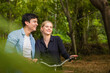 © calcassa - Young couple in love on bikes in the park