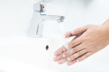 Wall Mural - Hygiene. Cleaning Hands. Washing hands with soap under the faucet with water.