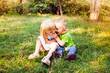 © justesfir - Funny little girl and boy play outdoors in summer