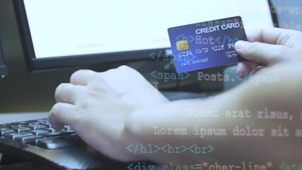 Poster - close up hand hold Credit Card and key in on keyboard with Coding overlay . Background for E-commerce and online shopping concept.