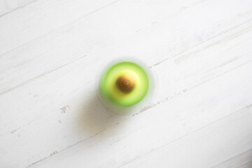 Wall Mural - Avocado on a wood white background