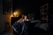 © Prins Productions - Young professional woman working from home in her room, late at night on laptop