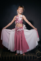 A little girl dressed as an belly dancer