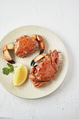 Wall Mural - Seafood. Boiled crabs on plate served with lemon, herb. 
Top view