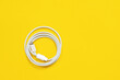 canvas print picture - May 01, 2020, Rostov, Russia: White Apple wire lightning to usb type c, arranged in round skein on bright yellow background.