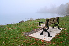 A Bench Overlooking Lake Ontario Before Sunrise On A Foggy Autumn Morning At Toronto`s Popular Ashbridges Bay Park.
