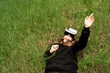 © Maxim - girl with virtual reality glasses lies on the grass with a surprised face
