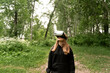 © Maxim - girl stands in the middle of the forest with virtual glasses