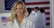 © vesperstock - CU Young blonde Caucasian woman in white lab coat with 'I Voted' sticker, in US election. Other scientists of various demographics, in lab coats, vote in background