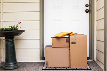 Front Entryway Of House With Stack Of Delivery Boxes From Online Ordering And E-commerce
