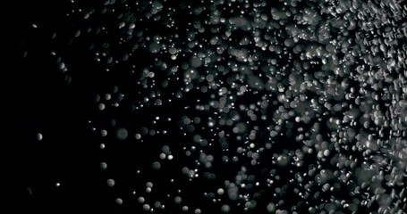 Wall Mural - snowflakes floating in the air slowly at night. it shows the white particles dropping from above slo