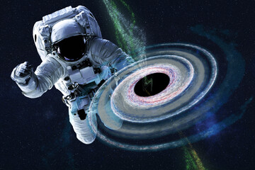 Wall Mural - astronaut near colourful black hole somewhere in space. dramatic space background. science fiction. 