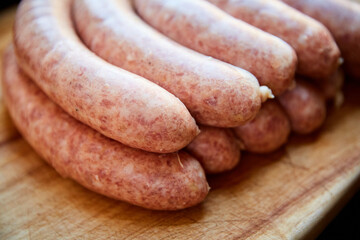 Homemade Hungarian Kolbasz Sausage Piled in Rows on Wooden Surface