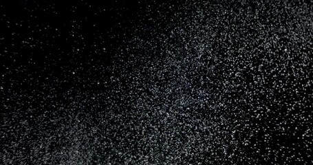 Wall Mural - glitter snowfall several snow particles falling down over a black background