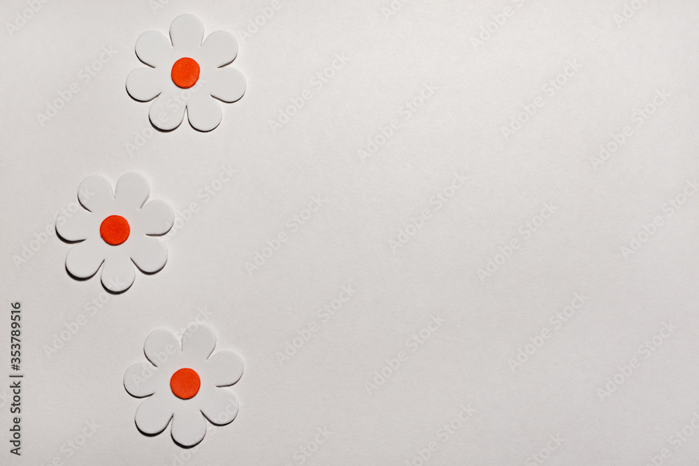 Cardboard sheet. Application of flowers on a sheet of paper. Three ...