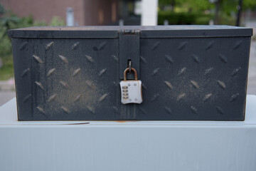 Wall Mural - rusty combination padlock in blue metallic tool box