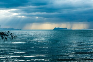 Wall Mural - Rays of light breaking thru rain storm clouds in Asia