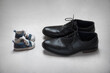Adult and Child, age concept, baby and adult shoes 
