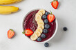 Blueberry smoothie, banana, chia seeds, fresh strawberries in bowl. Eating healthy breakfast bowl. Clean eating, dieting, detox, vegetarian, vegan food concept.