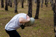 © elenaseiryk - Man taking off gas mask in pine forest. Enviromental protection, ecology, Earth saving, pollution prevention, crisis, health concept.