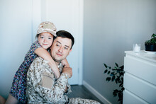 Military Man Father Hugs Daughter. Portrait Of Happy American Family.